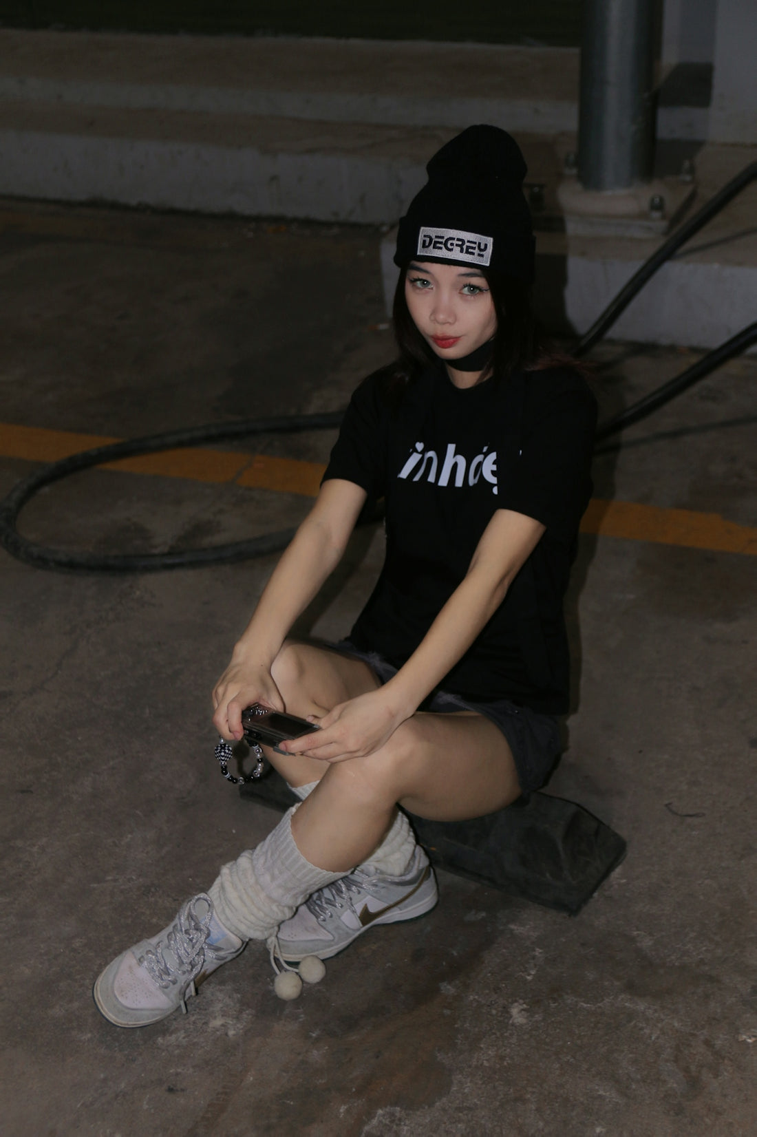 a woman sitting on the ground with a camera