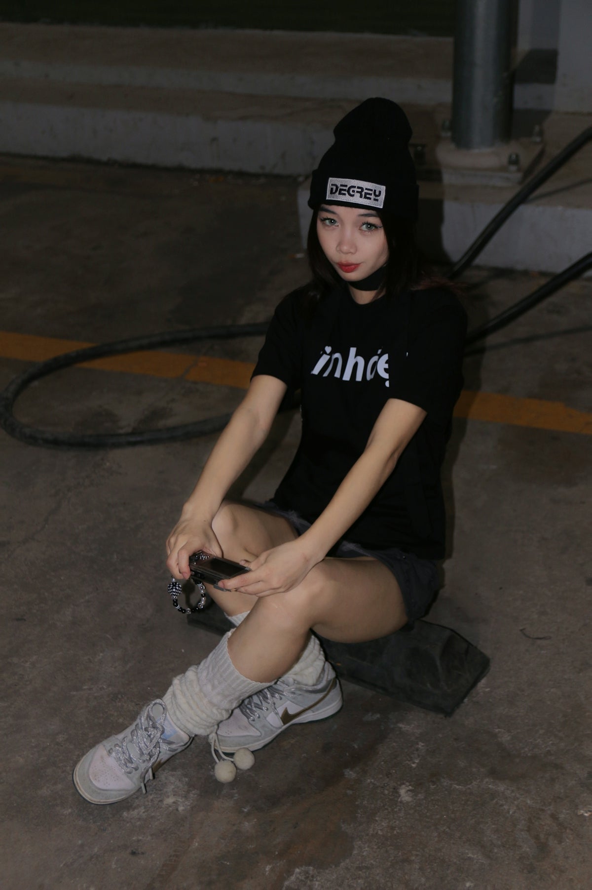 a woman sitting on the ground with a camera