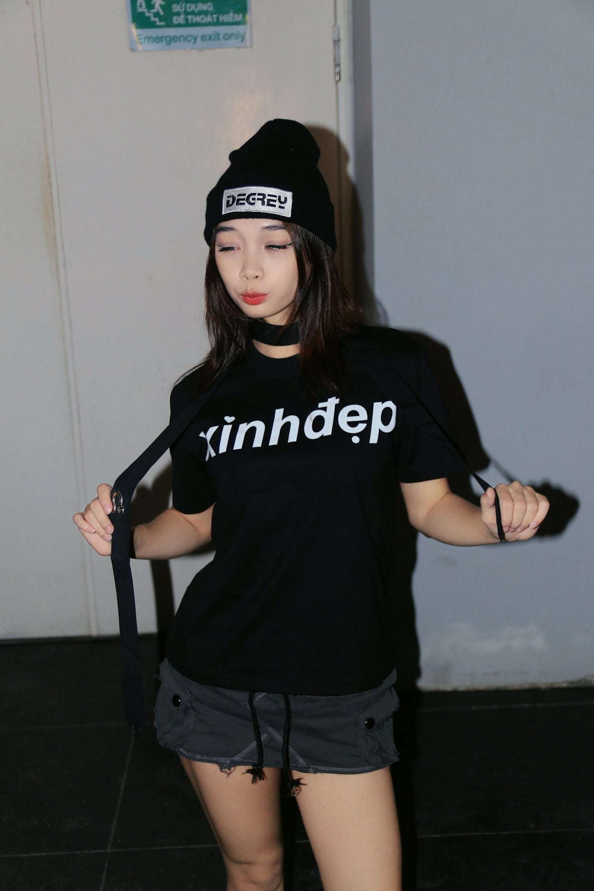 a woman wearing a black shirt and a black hat