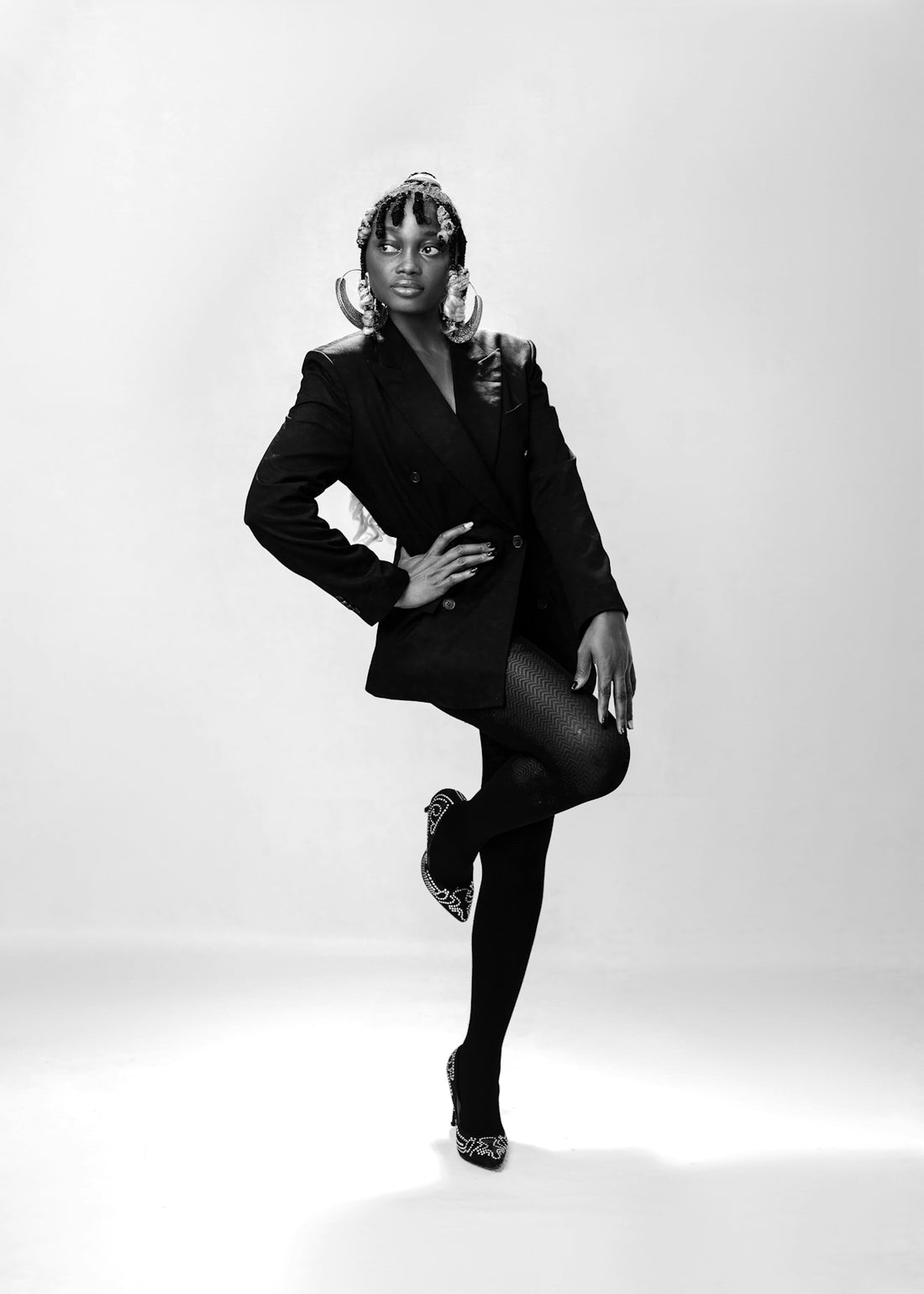 a black and white photo of a woman in a suit