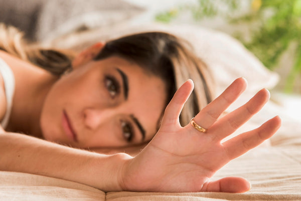 A beautiful woman laying on top of a bed