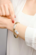 A woman wearing a bracelet with a tag on it