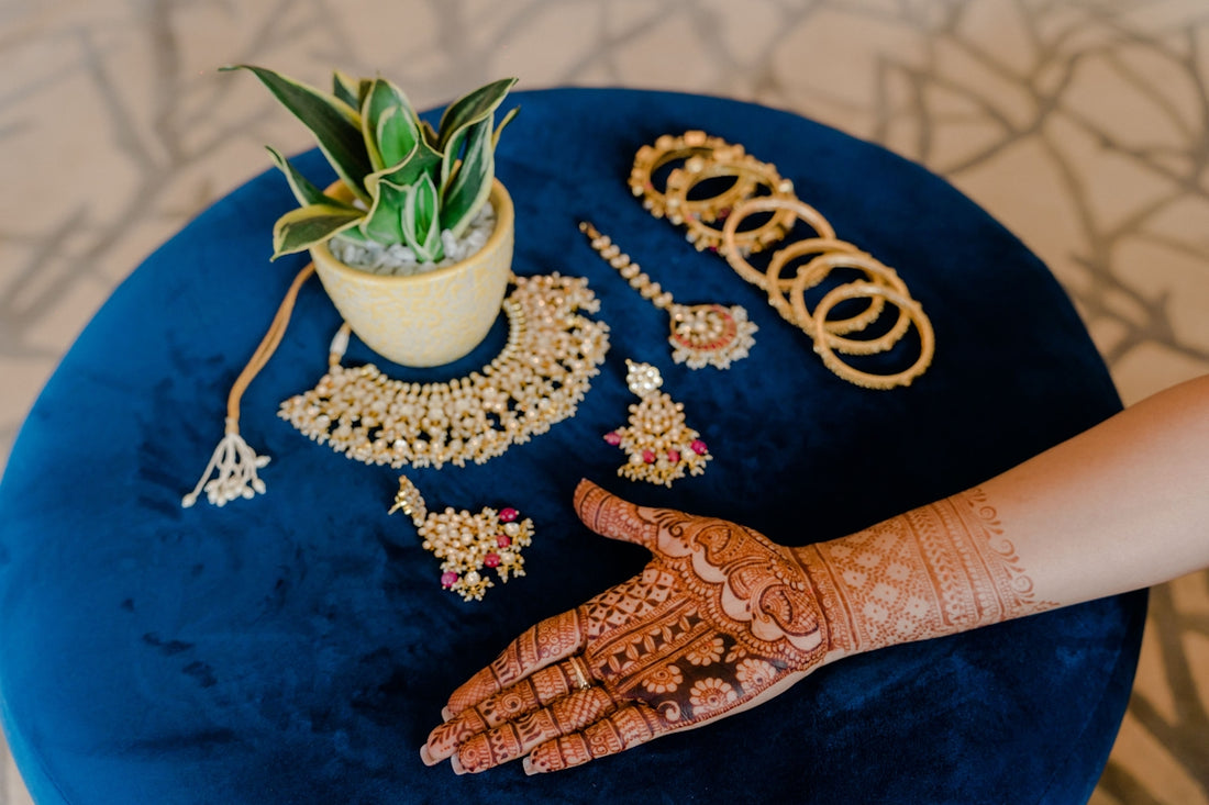 A blue table topped with a potted plant and jewelry