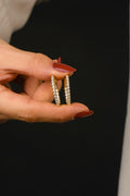 A woman holding two rings in her hand