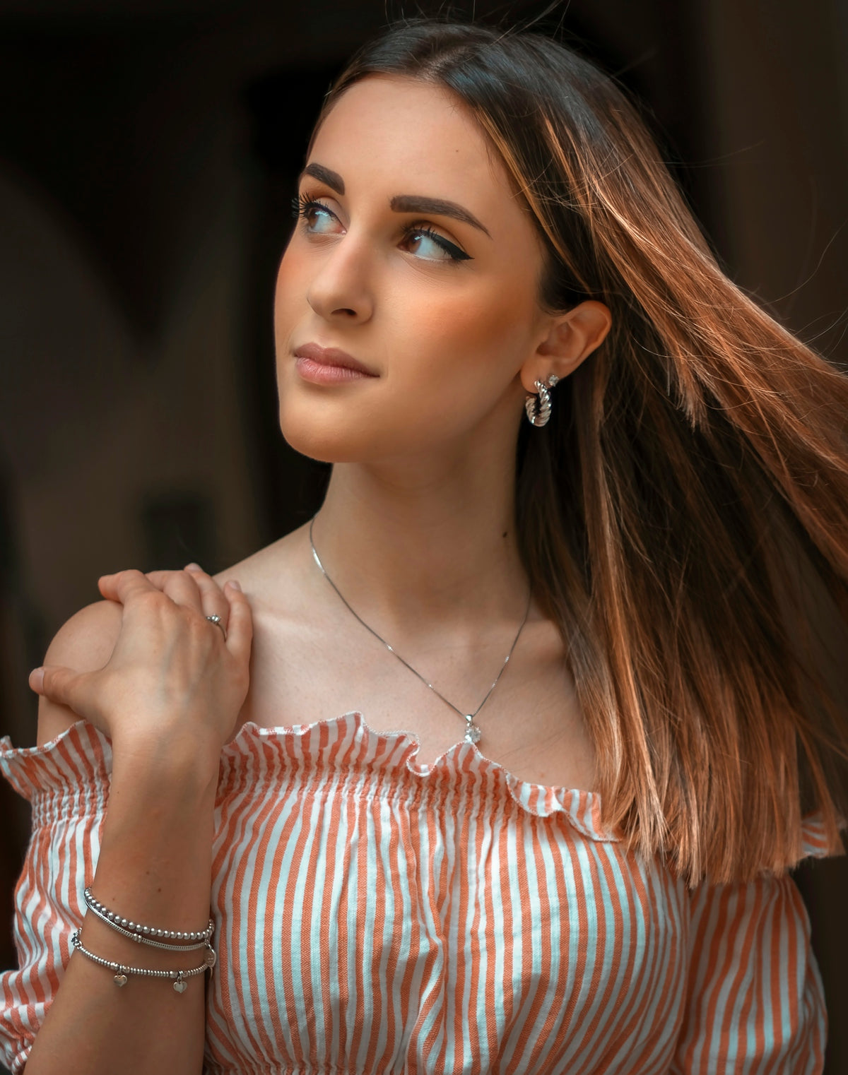 A woman with long hair wearing a striped shirt