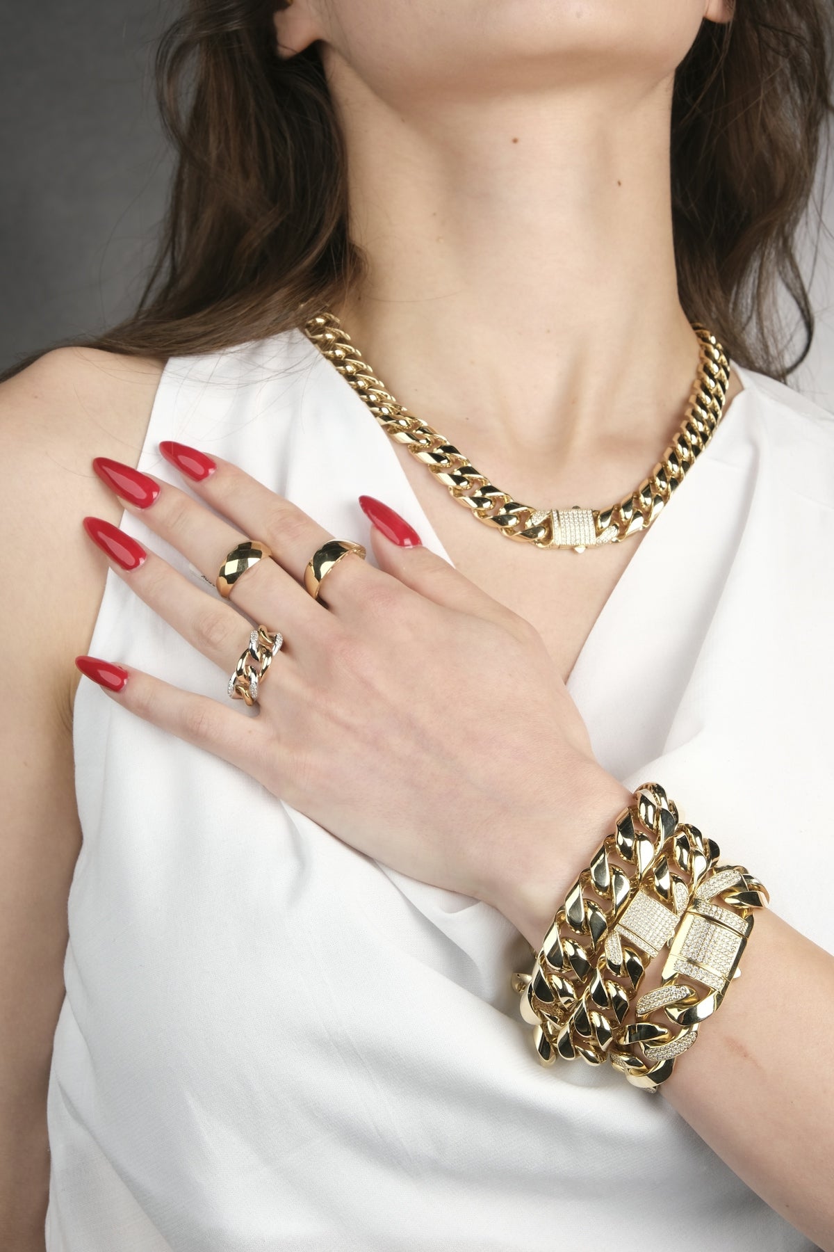 A woman in a white dress with red nails