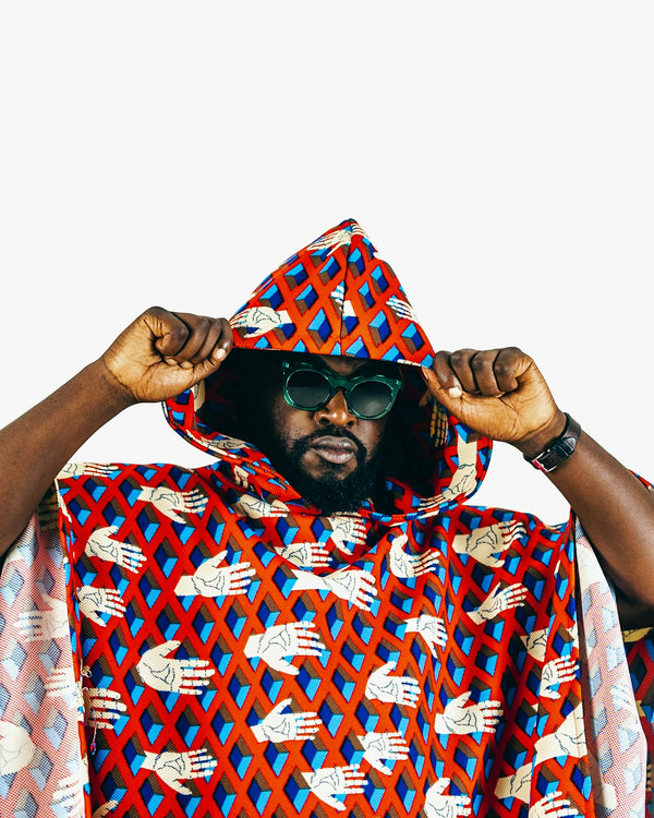A man in a red and blue patterned cape