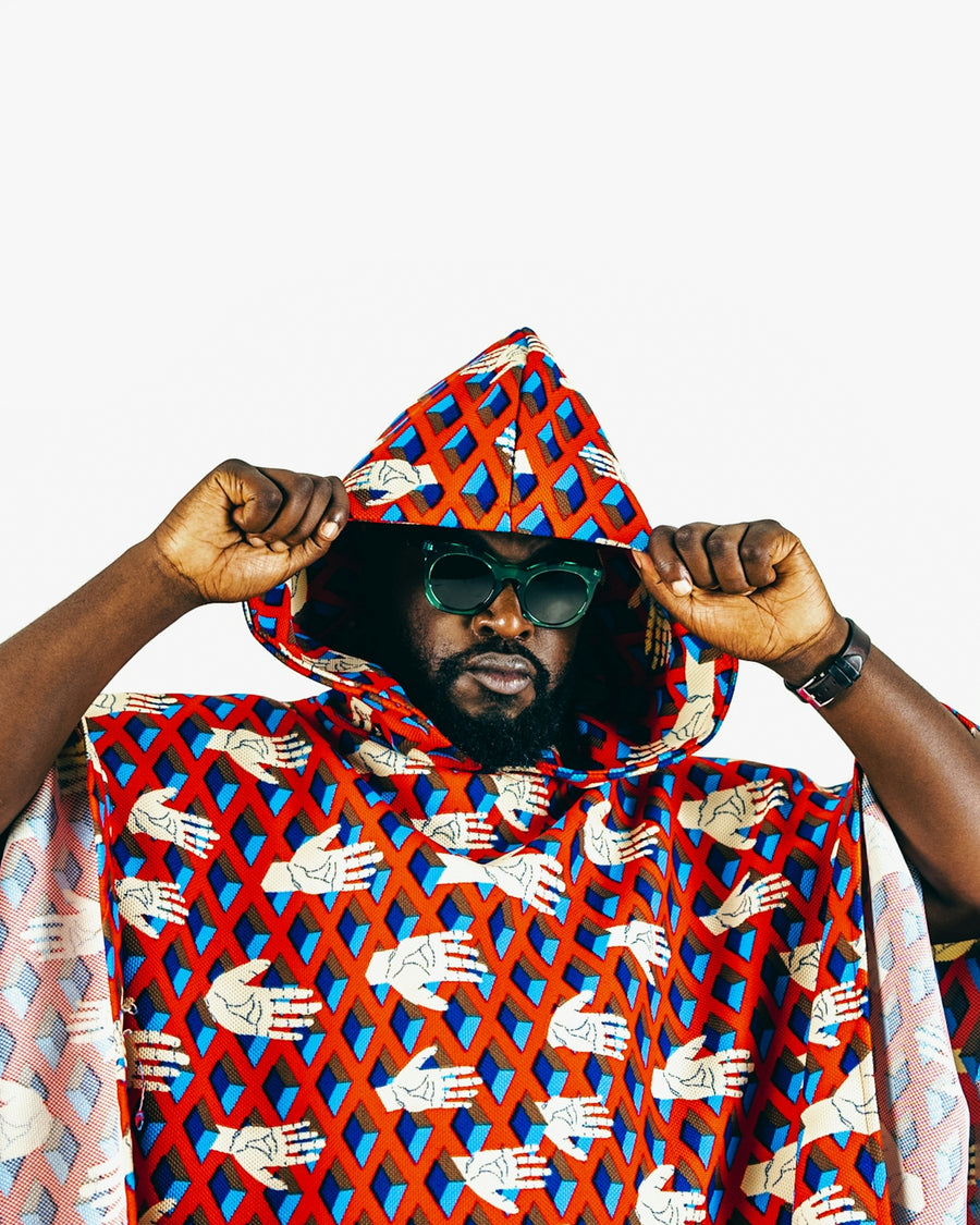 A man in a red and blue patterned cape