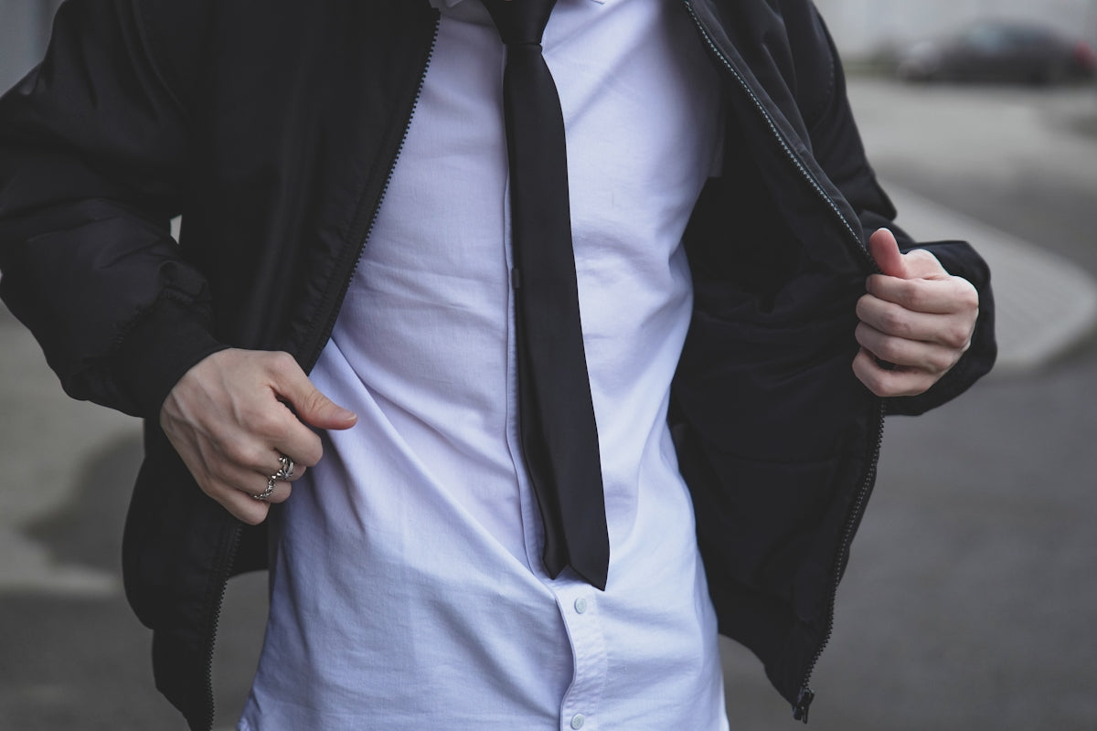 A man is wearing a suit jacket and tie.