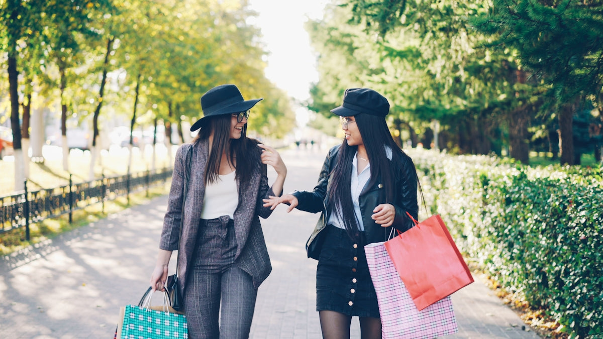 Two women with shopping bags walking together