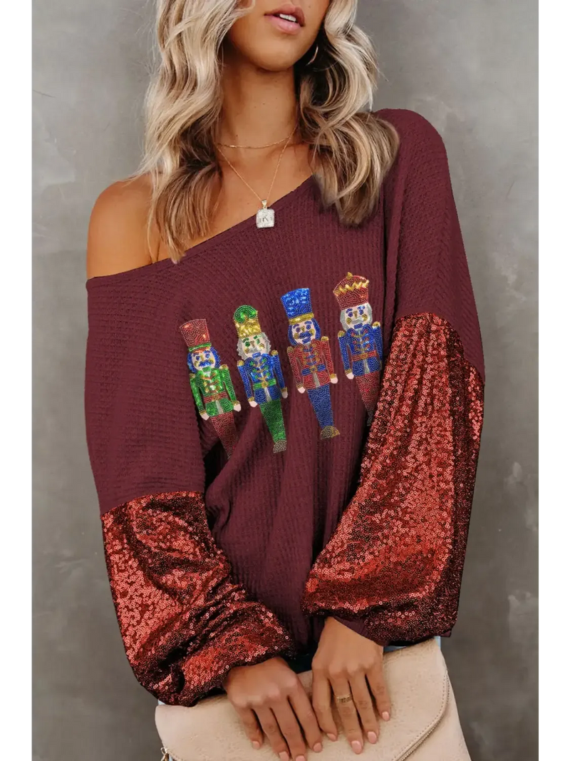 Exclusive women's graphic tops featuring a trendy design with sequined sleeves for a stylish look
