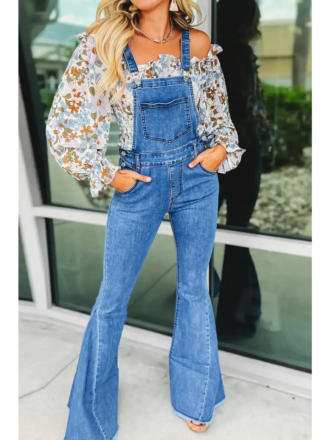 Stylish women's bottoms including flared denim overalls paired with a floral blouse for a chic look