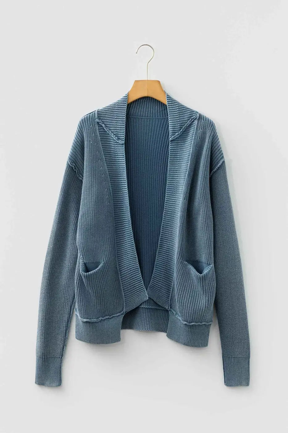 Front view of blue Women's Stonewash Patchwork Knit Open Cardigan on hanger, featuring open front and patch pockets.