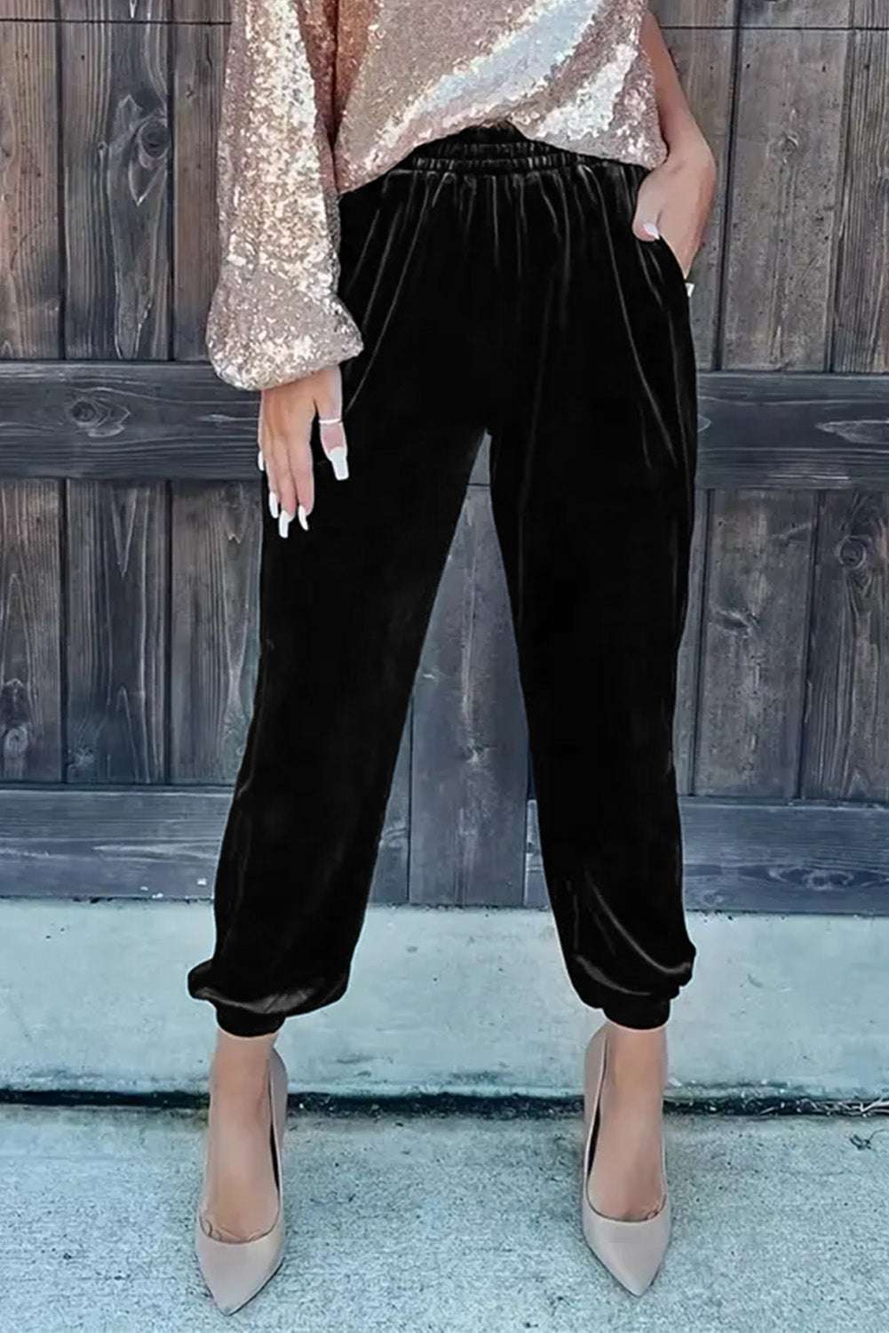 Women's Black Velvet Jogger Trousers paired with sequin top and heels, showcasing versatile loungewear for stylish daily outfits.