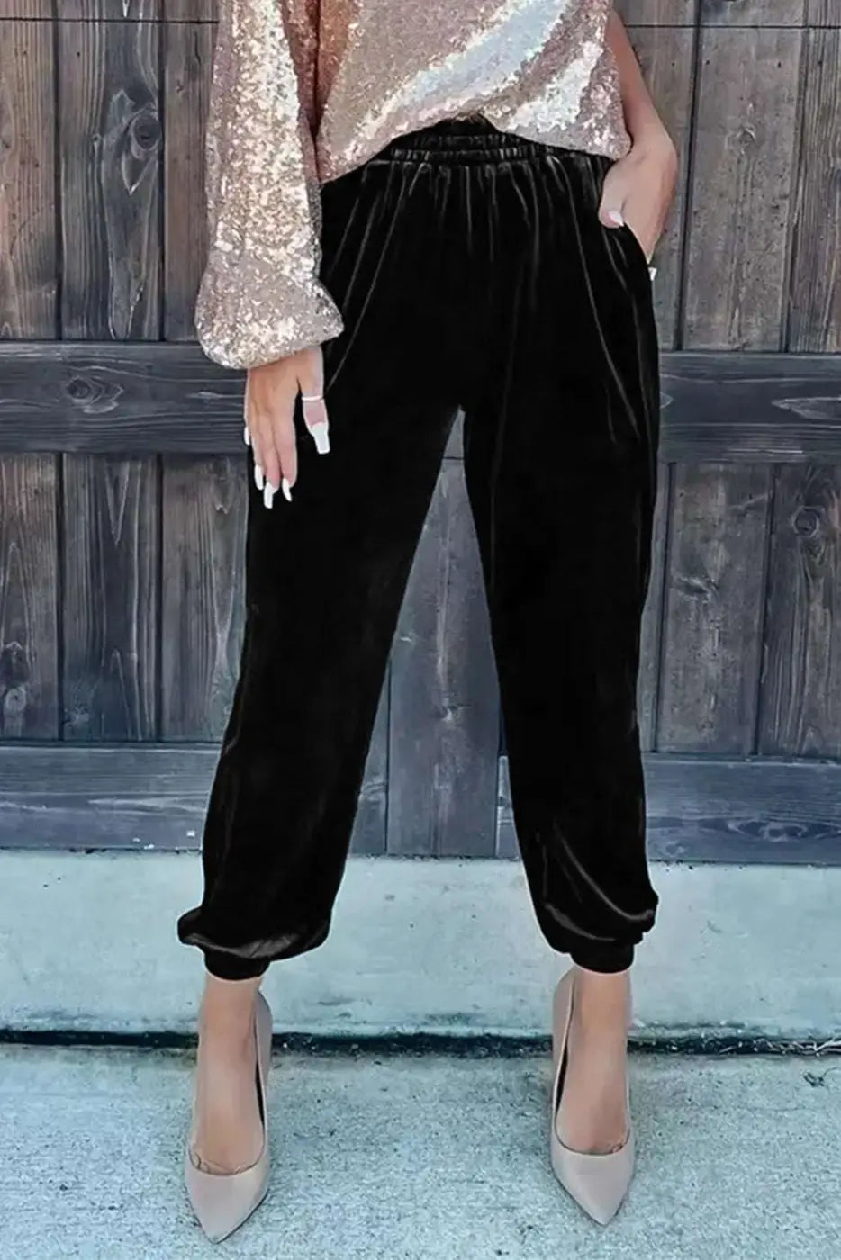 Women's Black Velvet Jogger Trousers paired with sequin top and heels, showcasing versatile loungewear for stylish daily outfits.