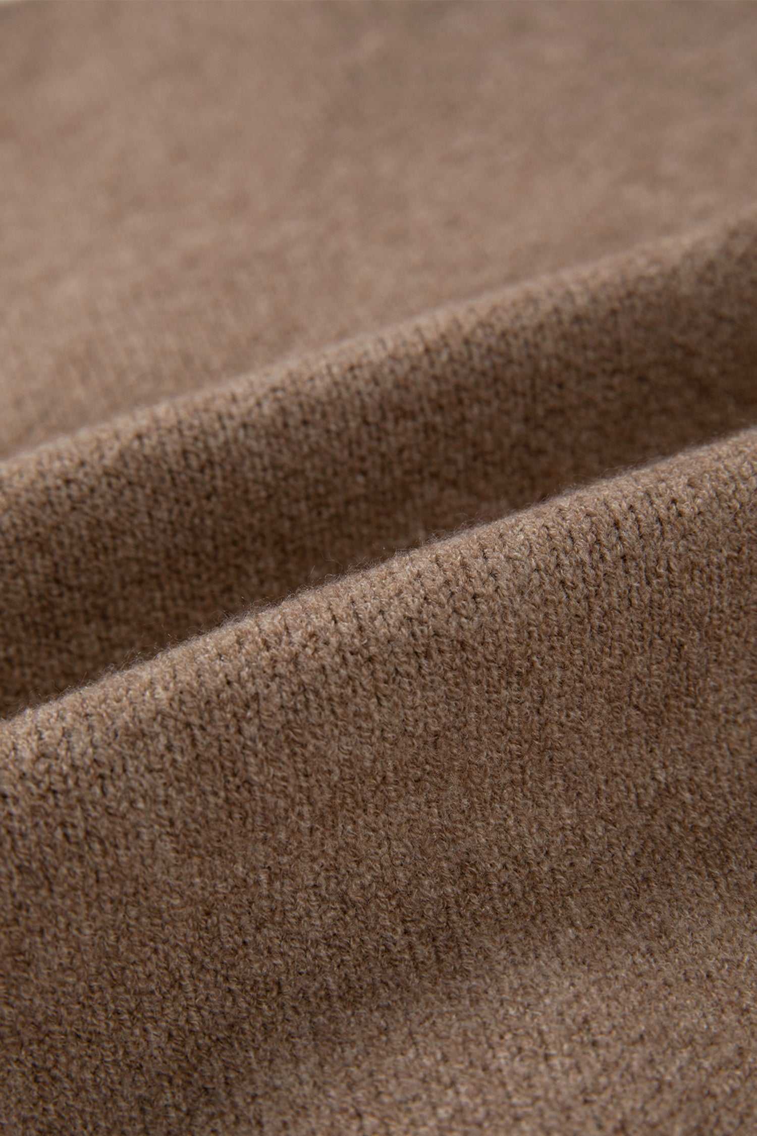 Fabric close-up of khaki knit cardigan showing soft, textured material. Perfect for cozy, smart-casual layering in cooler seasons.