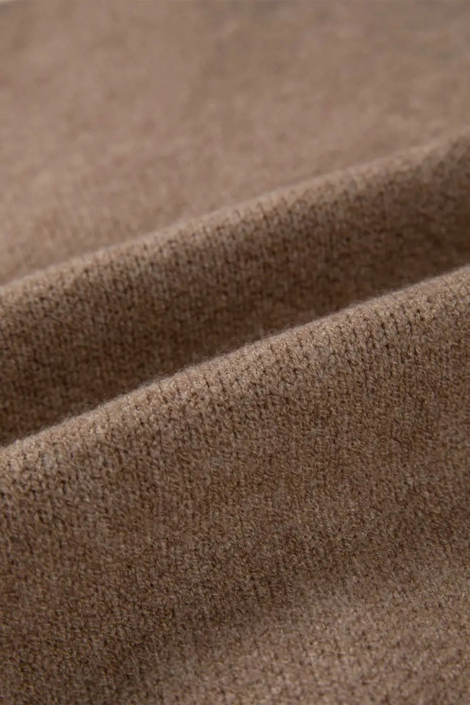 Fabric close-up of khaki knit cardigan showing soft, textured material. Perfect for cozy, smart-casual layering in cooler seasons.