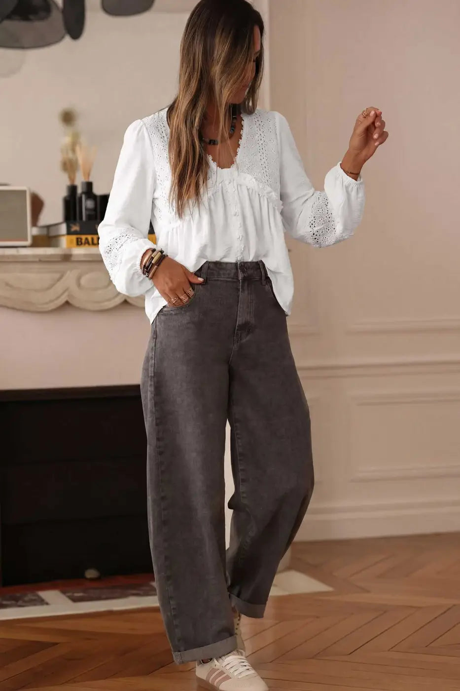 White Guipure Lace Frill Blouse paired with wide-leg grey jeans and sneakers, perfect for a relaxed yet elegant daytime outfit.