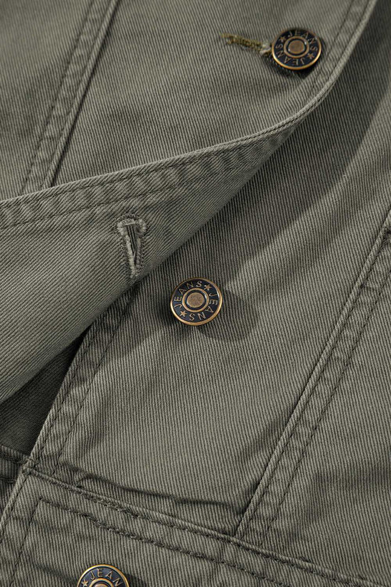 Close-up of button and stitching on Green Bay Ruffled Denim Vest - Women's Fashion Trends highlighting quality craftsmanship and western style.
