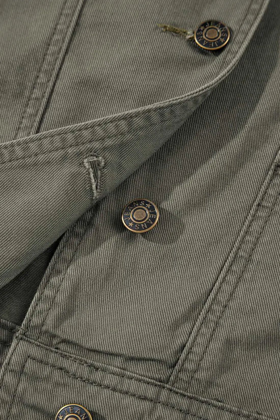 Close-up of button and stitching on Green Bay Ruffled Denim Vest - Women's Fashion Trends highlighting quality craftsmanship and western style.