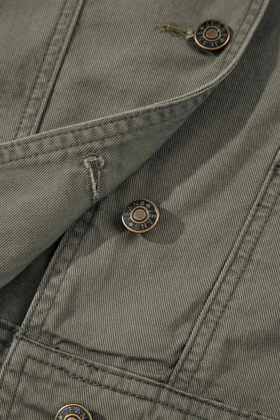 Close-up of button and stitching on Green Bay Ruffled Denim Vest - Women's Fashion Trends highlighting quality craftsmanship and western style.