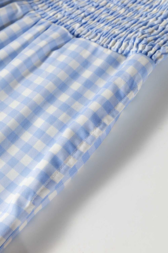 Close-up of elastic waistband on plaid wide leg trousers