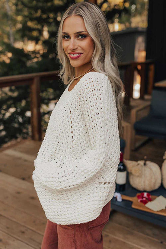 Side view of white wide sleeve hollow knit jumper styled with rust pants, perfect for lightweight fall layering.