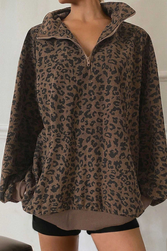 Brown leopard print corduroy half-zip jumper for women, featuring a loose fit and ribbed hem, ideal for autumn layering.