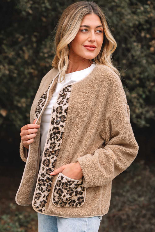 Side angle of women’s plush leopard print jacket with cozy fleece fabric and bold animal print accents on front and pockets.