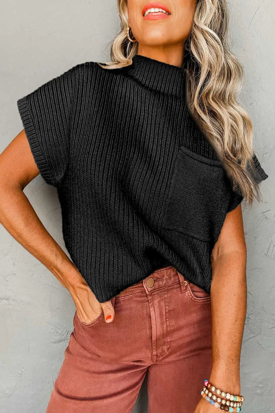 Woman wearing black ribbed knit short sleeve sweater with chest pocket, styled casually with high-waisted pants for effortless comfort.