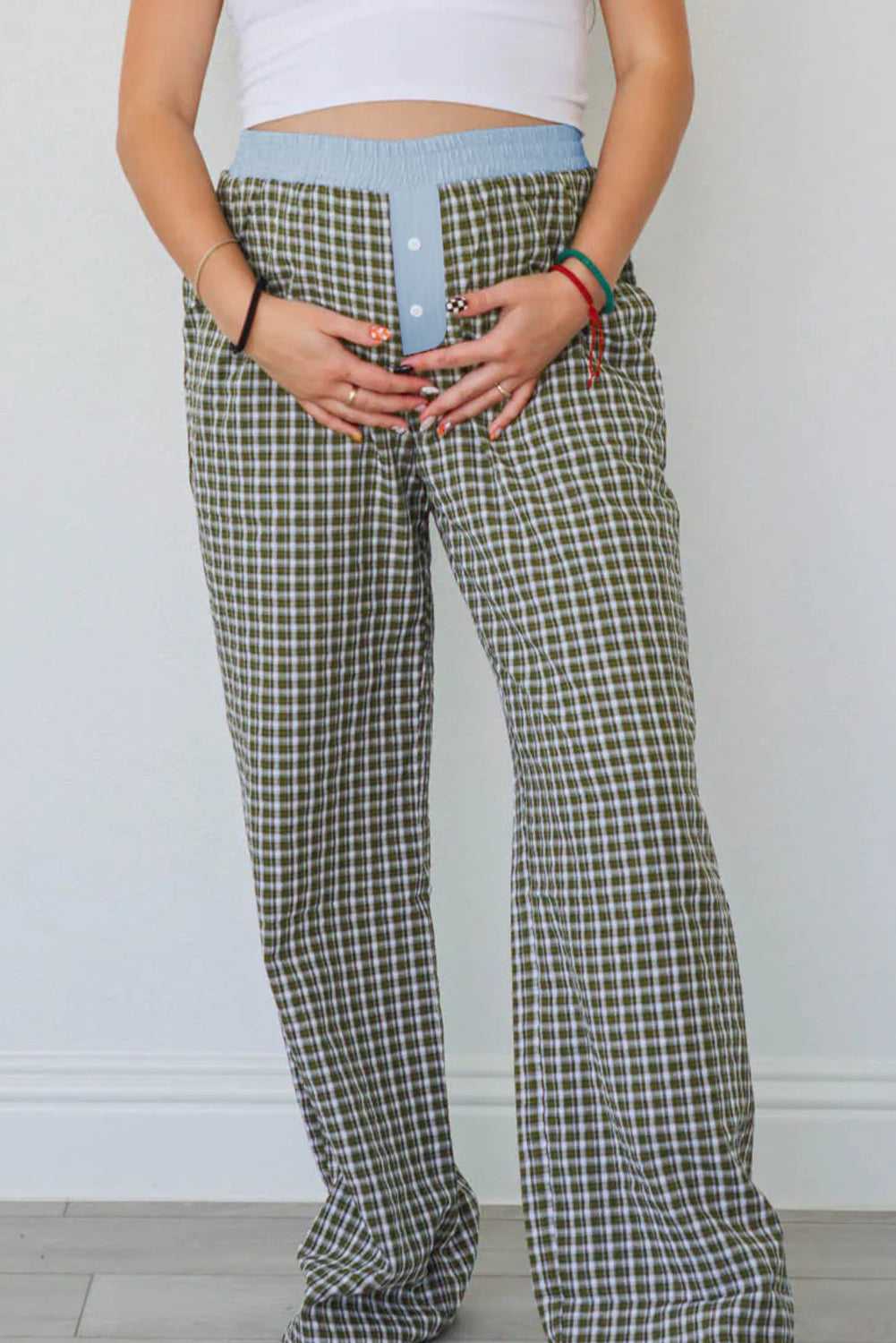 Front view of Ladies Brown Gingham Boxer Trousers by FashionFitz with hands on waistband, showing casual fit and fall-ready gingham pattern.