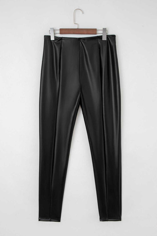 Back view of Black Vegan Leather Leggings – High‑Rise Skinny Fit on hanger, displaying smooth PU leather and high-rise waistband.