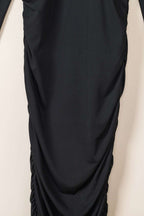 Close-up of ruched detailing on the skirt of the Ladies Black Wrap Drape Midi Dress, showcasing texture and body-contouring fit.