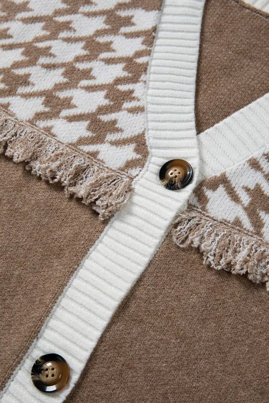 Detail of button placket and fringe trim on khaki houndstooth knit cardigan. Features white ribbed edges for a cozy, casual look.