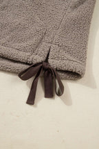 Close-up of brown ribbon bow tie at hem of Women's Country Borg Fleece Gilet Winter Vest FashionFitz, adding adjustable fit and charm.