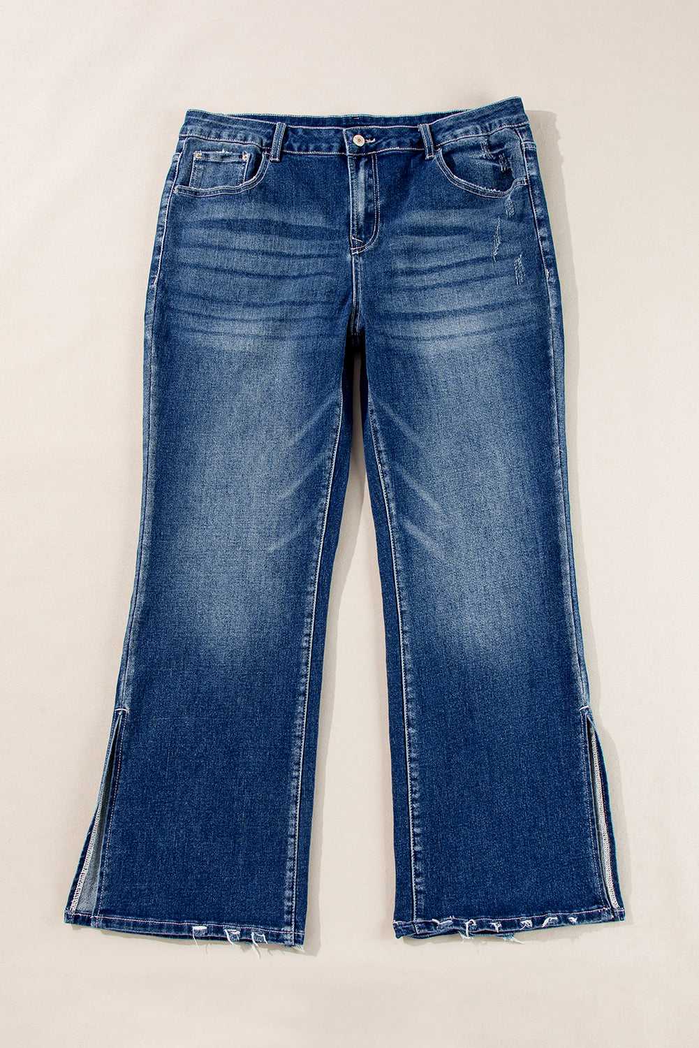 Flat lay of Dirty Blue Side‑Slit Flare Jeans – Curve displaying front design, flare legs, and side slits in solid blue denim.