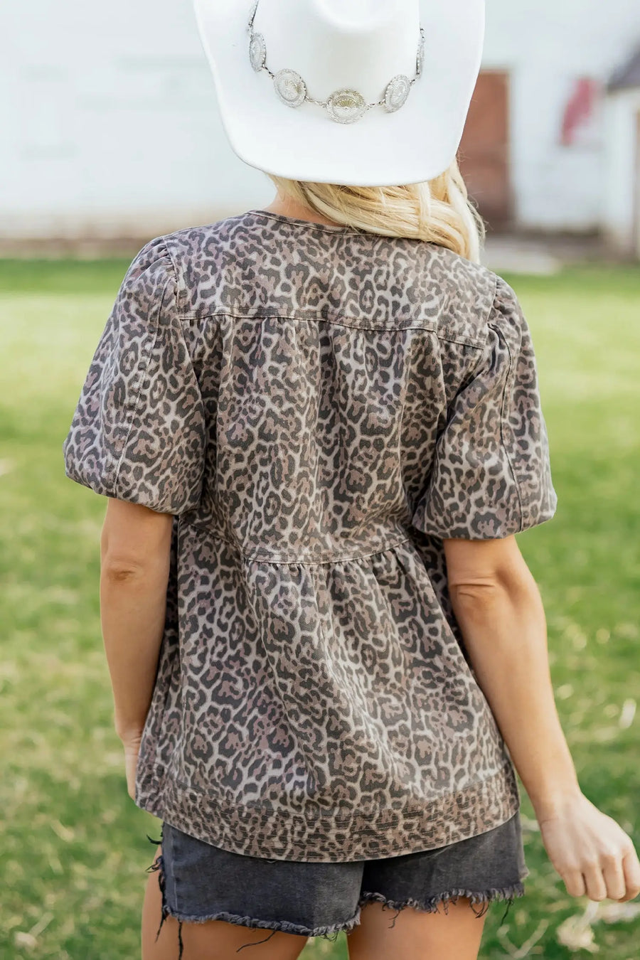 Back view of Leopard Tie Neck Puff Sleeve Babydoll Top showing tiered denim hem and babydoll silhouette — Fashionfitz