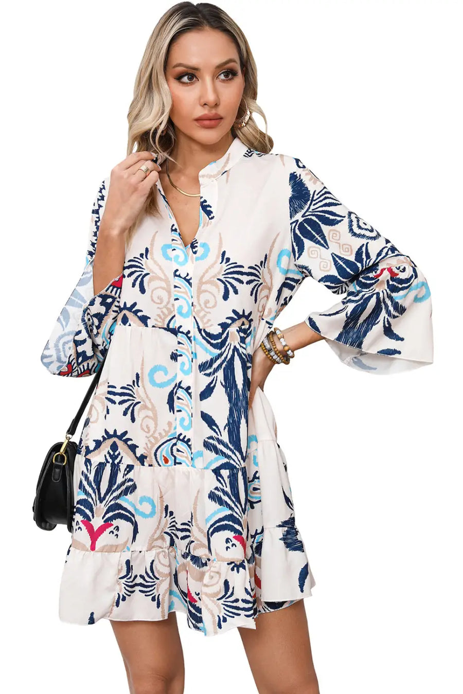 Model styling the Tribal Mini Dress with bracelet sleeves and a black handbag, perfect for a chic bohemian outfit.