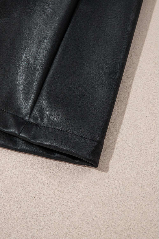 Hem detail of Black Vegan Leather Sleeveless Mini Dress, featuring clean stitching and soft PU leather for a polished look.