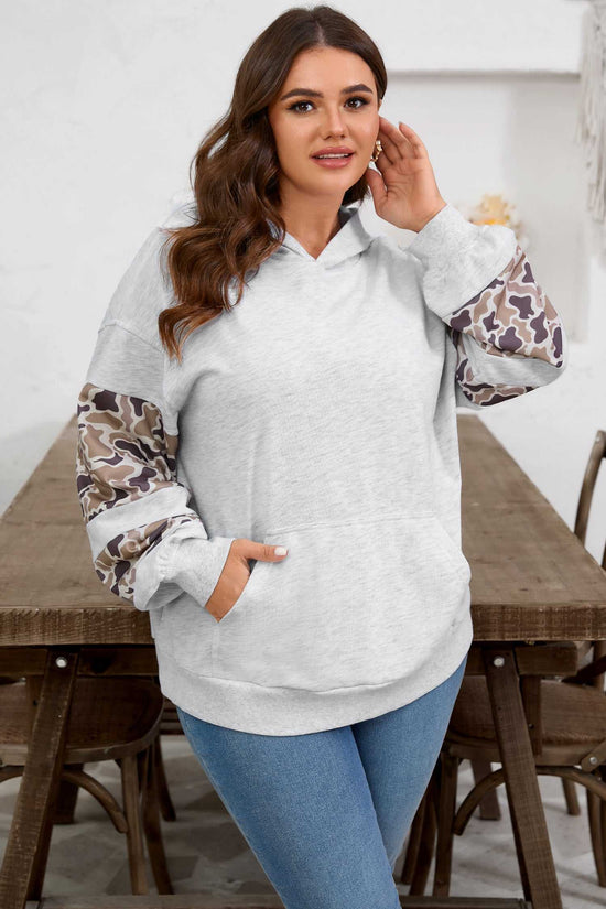 Women's Curve Light Grey Camo Panel Hoodie styled with jeans, showcasing camo patchwork sleeves and a soft relaxed fit.