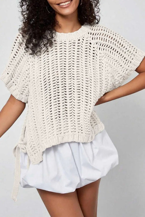 Plus Size Bow Tie Open‑Knit Jumper for Women in cream with short sleeves and bow detail, styled with white bubble shorts.