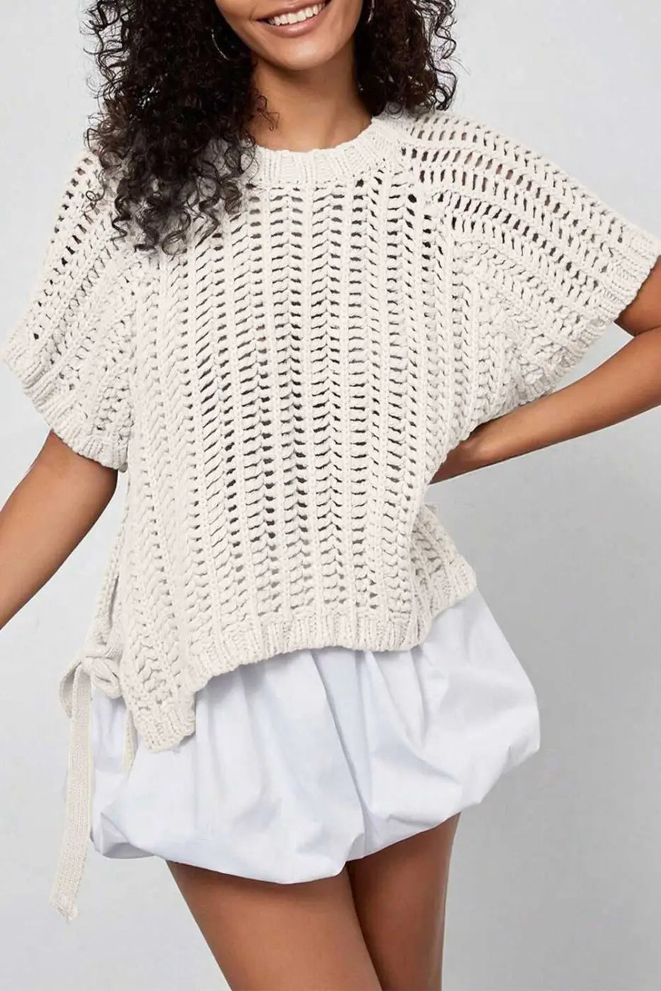 Plus Size Bow Tie Open‑Knit Jumper for Women in cream with short sleeves and bow detail, styled with white bubble shorts.