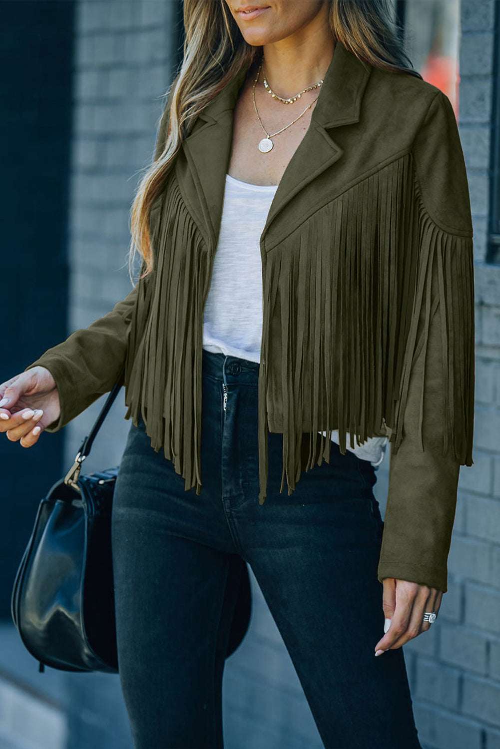 Green faux suede cropped jacket with fringe detail, styled with a white tee and black jeans for a trendy fall outerwear look.