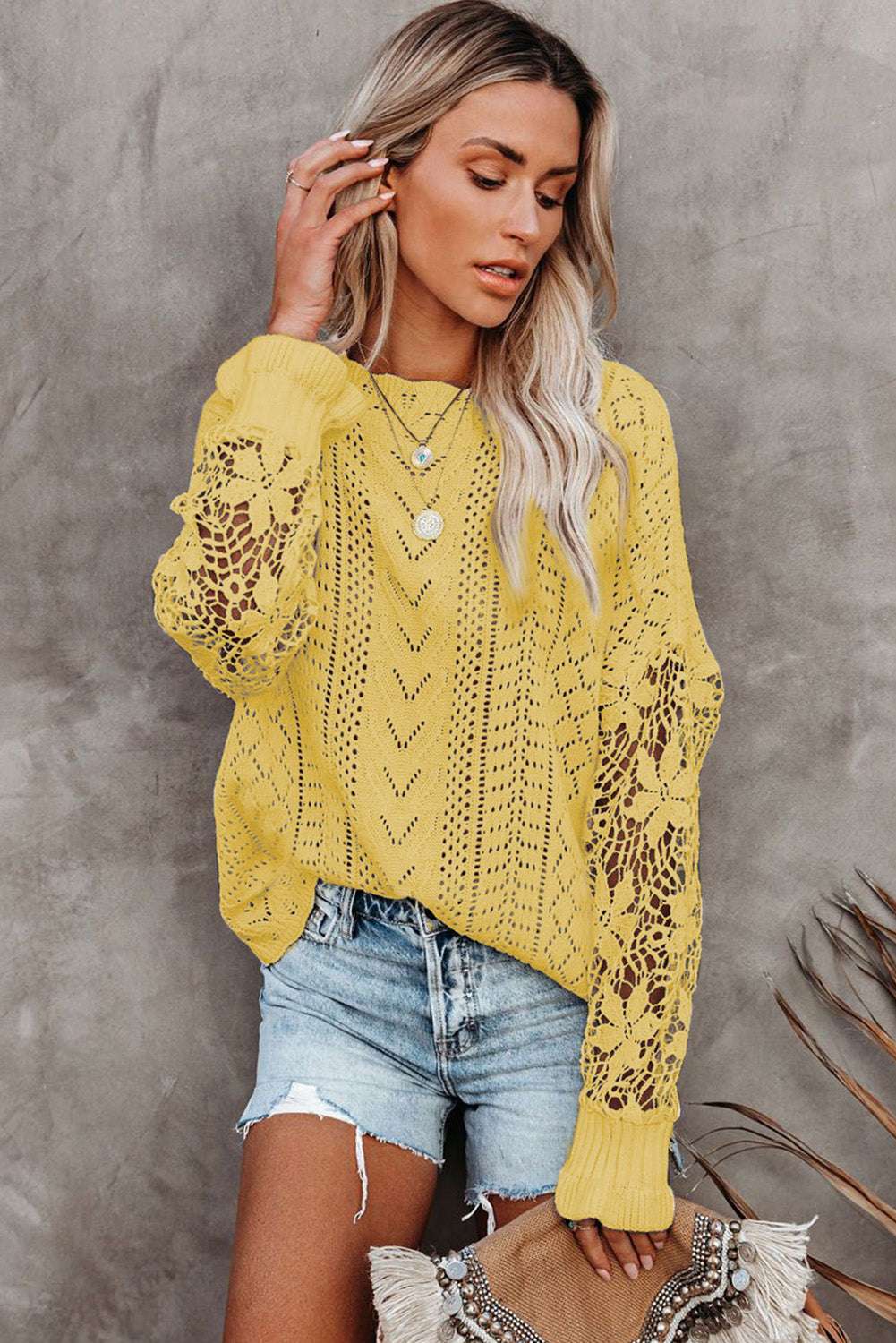 Model wearing Yellow Crochet Lace Pointelle Knit Sweater with layered necklaces, showcasing its feminine lace design and spring-ready style.