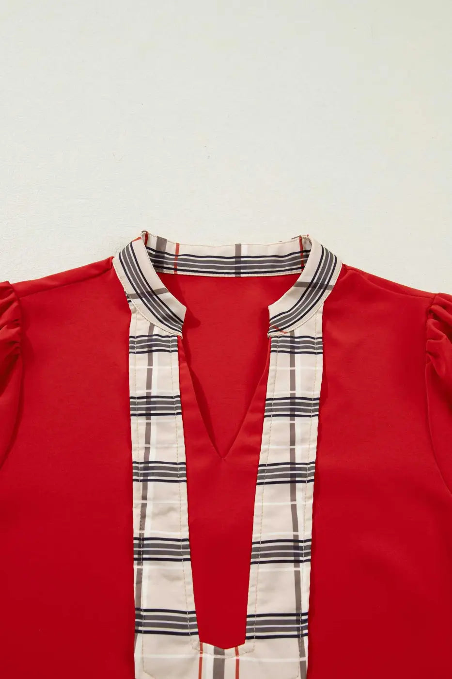 Close-up of Red Tartan Fusion V‑Neck Blouse neckline with beige plaid trim, emphasizing modern check design.