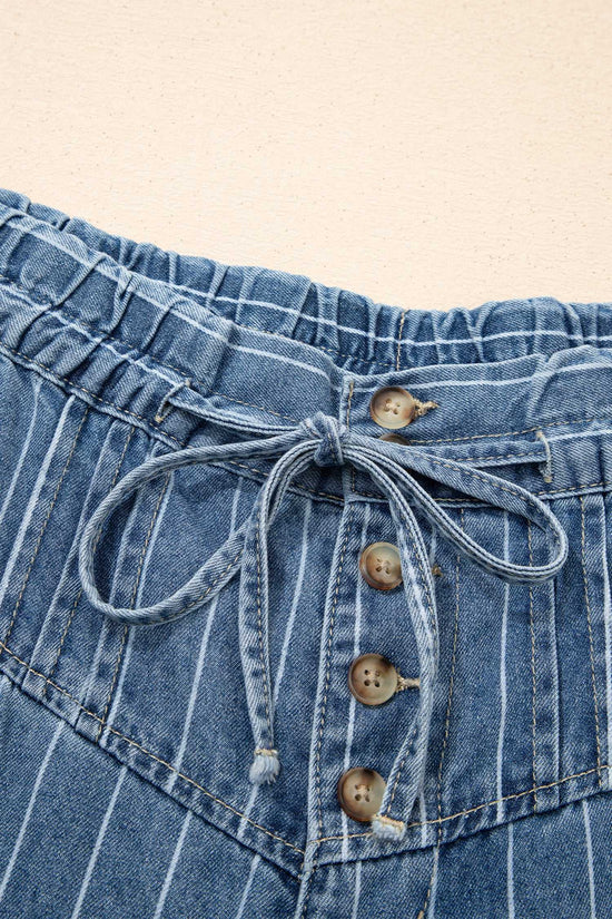 Close-up of drawstring waistband and button fly on women's pinstripe wide leg jeans, showcasing soft cotton denim texture.