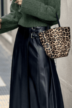 Black Faux Leather Pleated Flared Skirt | FashionFitz paired with leopard print bag, emphasizing the high-waist buckle detail and sleek PU leather finish.
