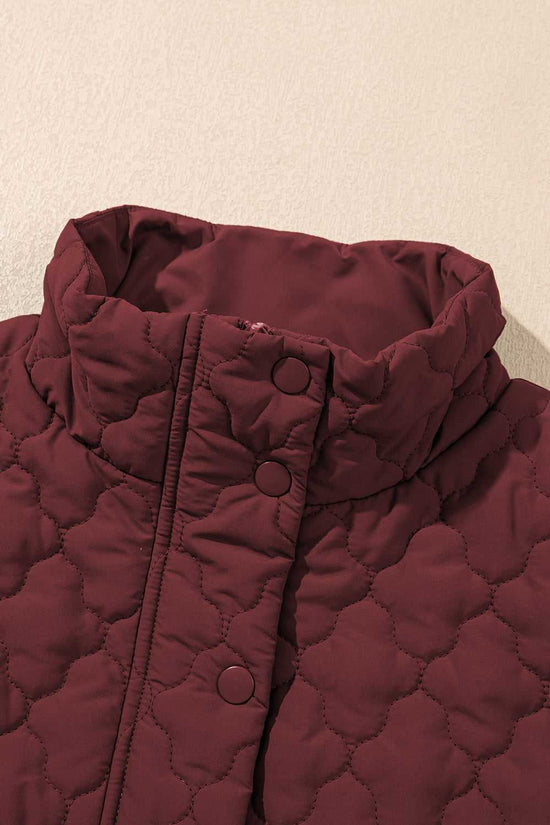 High collar detail of burgundy Flower‑Quilted Winter Gilet with snap buttons, showcasing padded warmth and stylish neckline for winter fashion.