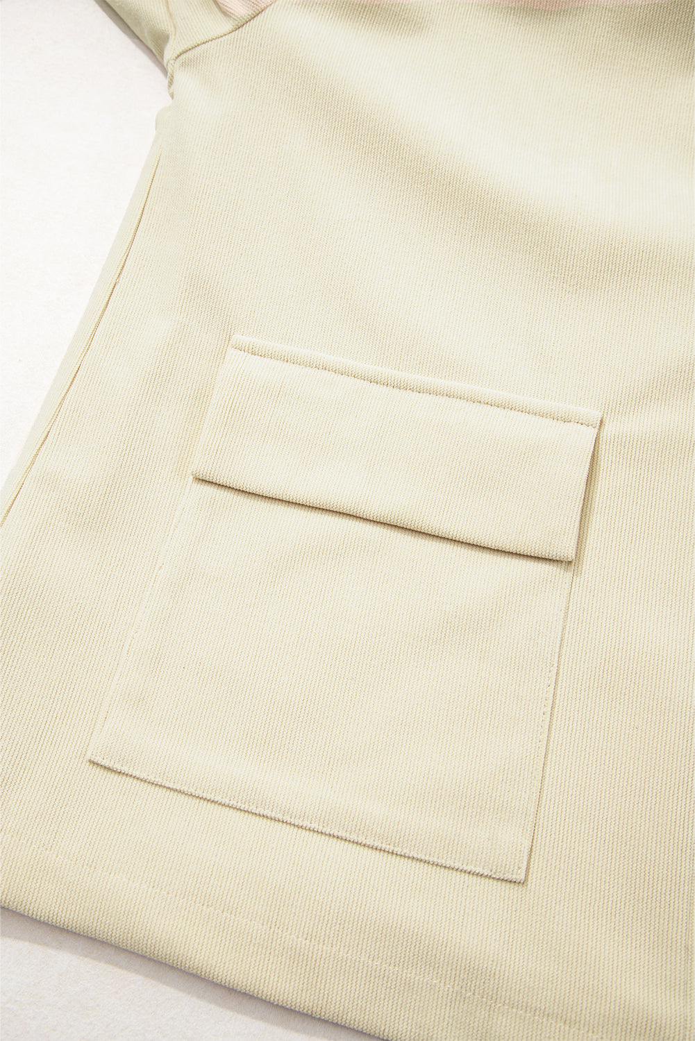 Beige fabric with a pocket on a light background