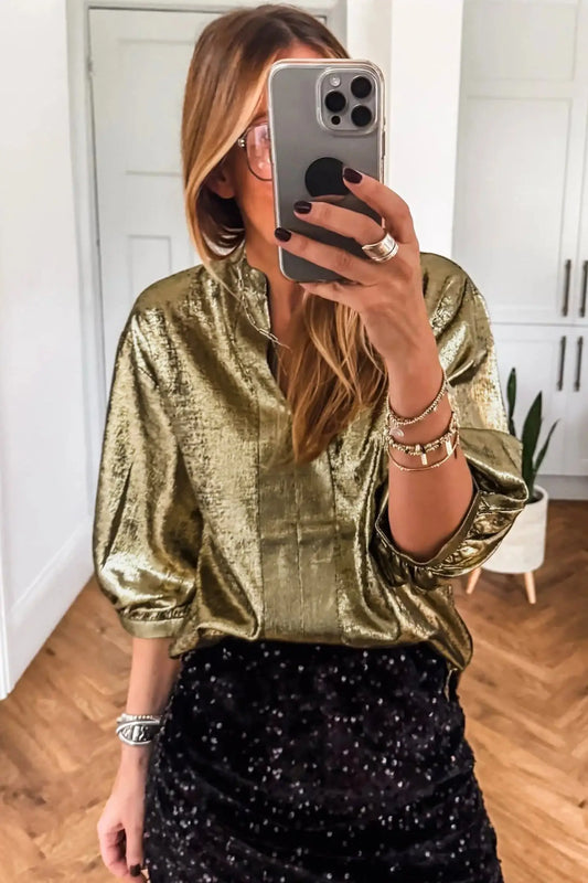 Gold metallic blouse showing split neckline and half sleeve detail under studio lighting Fashionfitz UK